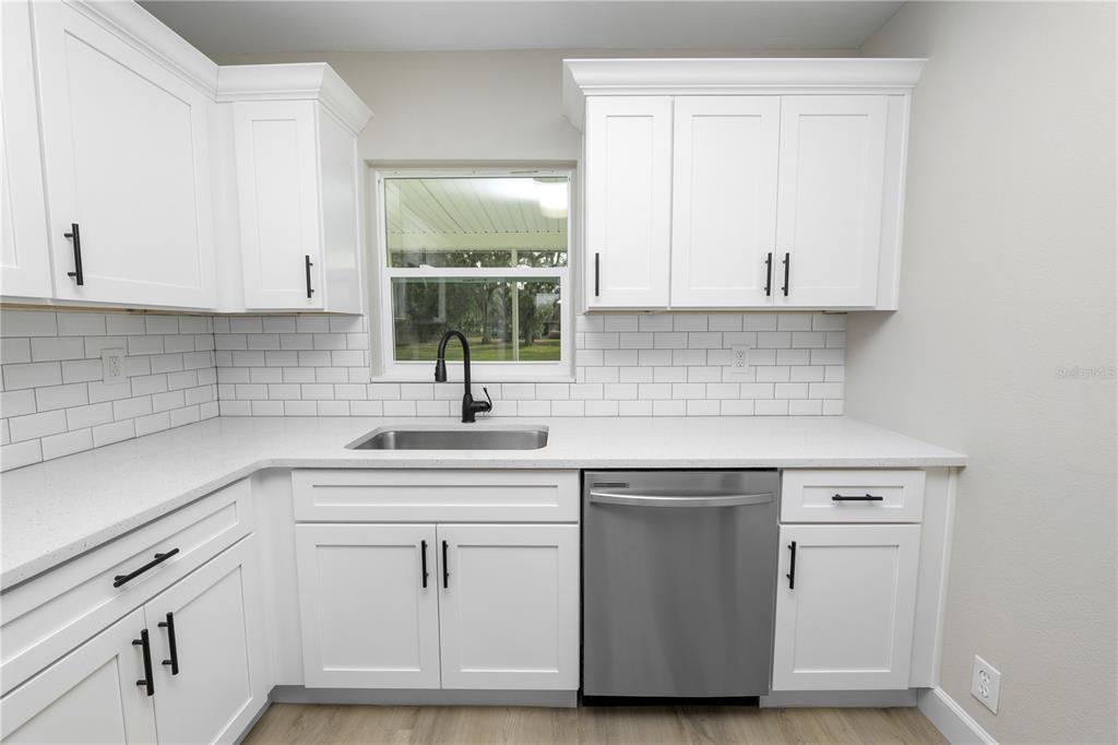 5105 Hayes Road Lakeland, FL 33811 - Photo 6 of 43 a kitchen with white cabinets appliances a sink and a window