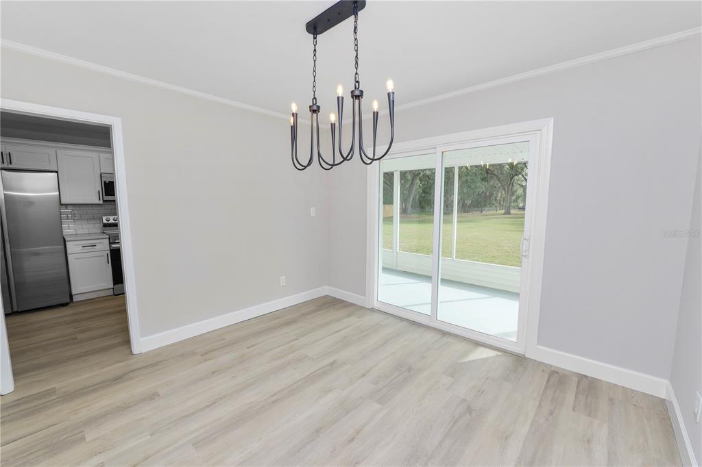 5105 Hayes Road Lakeland, FL 33811 - Photo 7 of 43 a view of an empty room with window and wooden floor