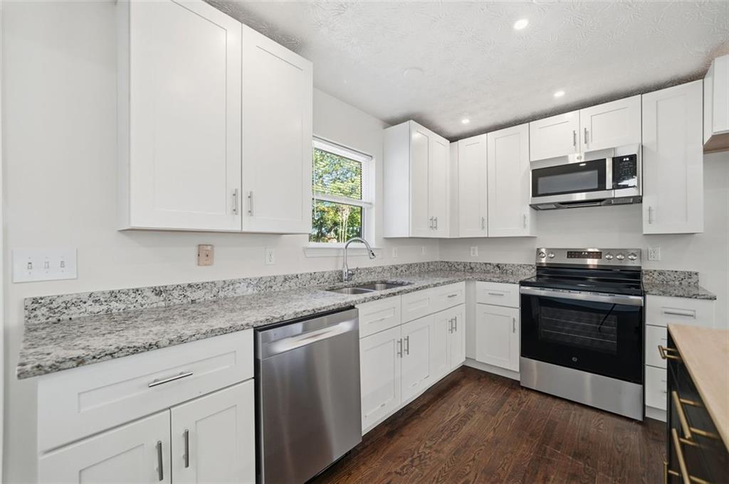 1512 Upper Sassafras Road Jasper, GA 30143 - Photo 15 of 35 a kitchen with stainless steel appliances granite countertop a sink and a stove
