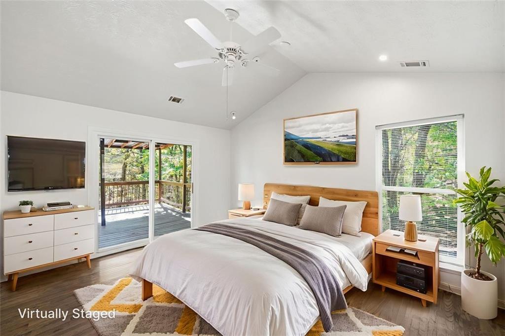 1512 Upper Sassafras Road Jasper, GA 30143 - Photo 17 of 35 a spacious bedroom with a bed and a flat screen tv