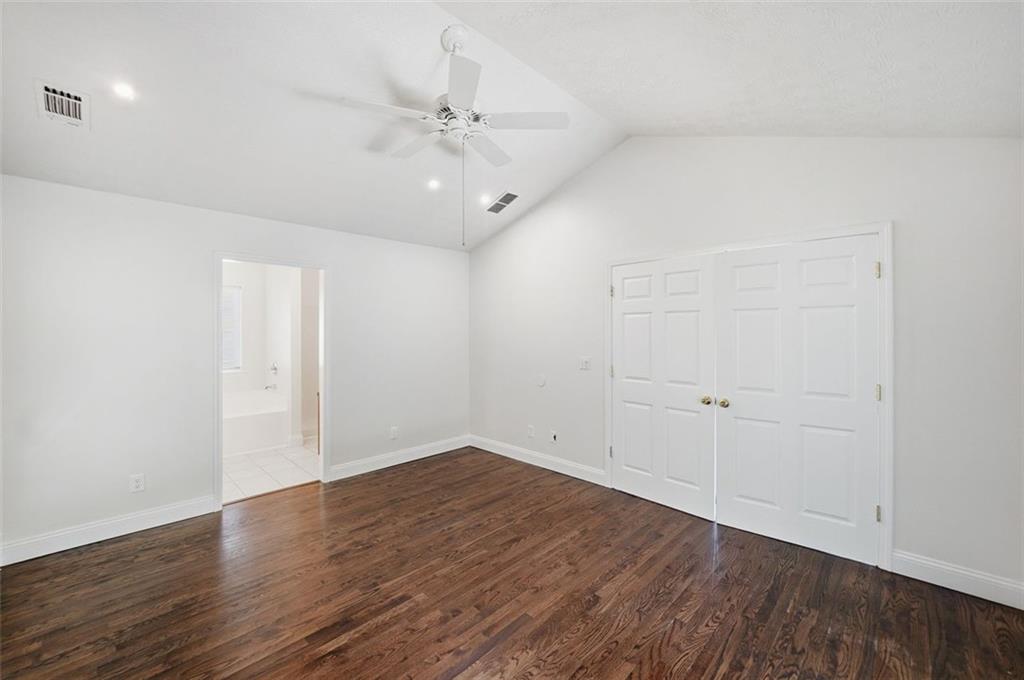 1512 Upper Sassafras Road Jasper, GA 30143 - Photo 19 of 35 an empty room with wooden floor and fan