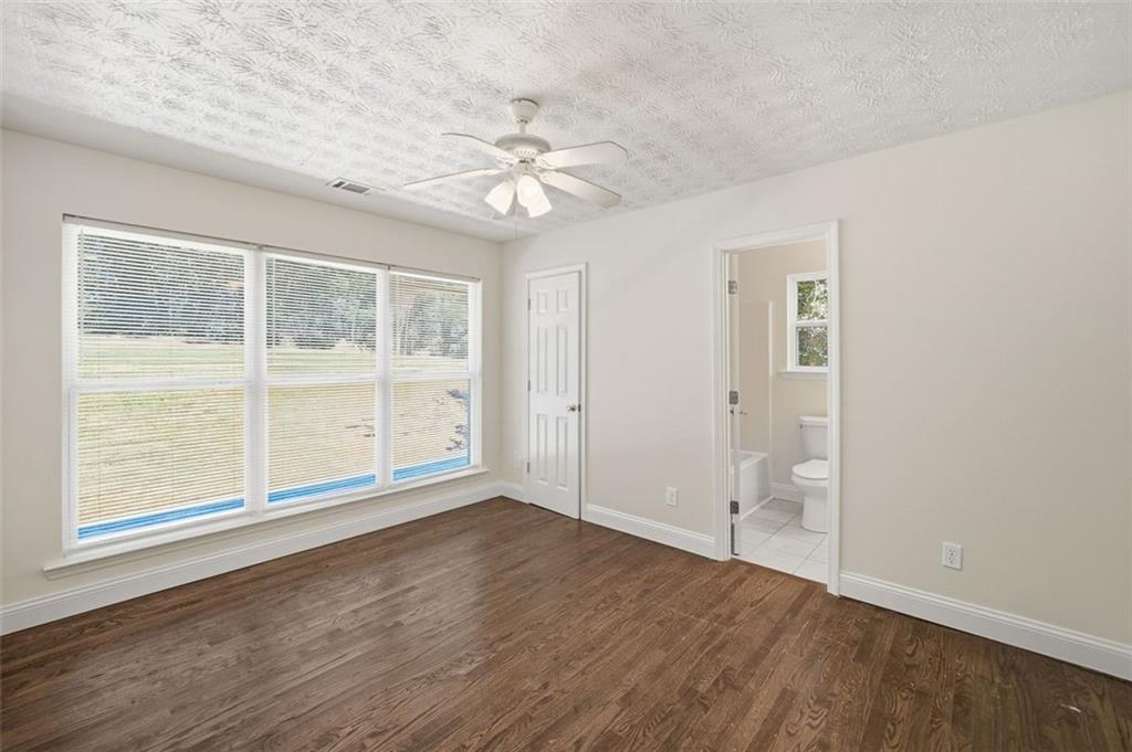 1512 Upper Sassafras Road Jasper, GA 30143 - Photo 25 of 35 wooden floor in an empty room with a window