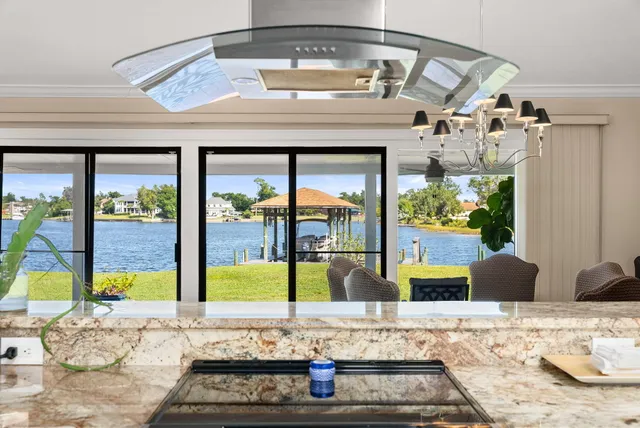 a large kitchen with stainless steel appliances granite countertop a stove and large sink