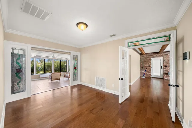 a living room with furniture and large windows