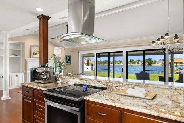 a view of a kitchen with granite countertop a sink and a counter top space