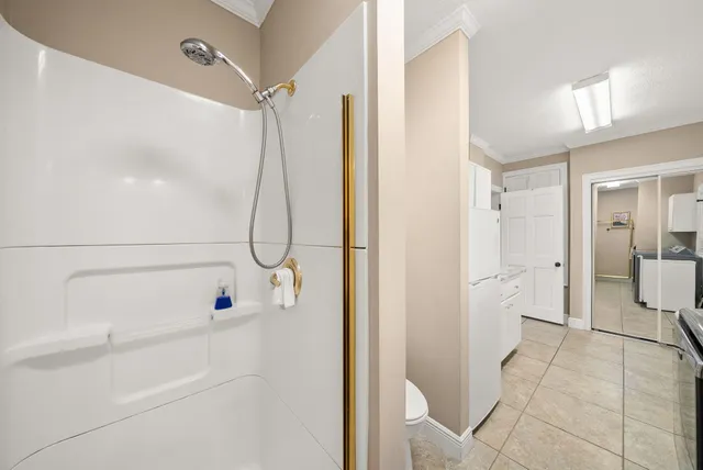 a spacious bathroom with a granite countertop sink a toilet and a mirror