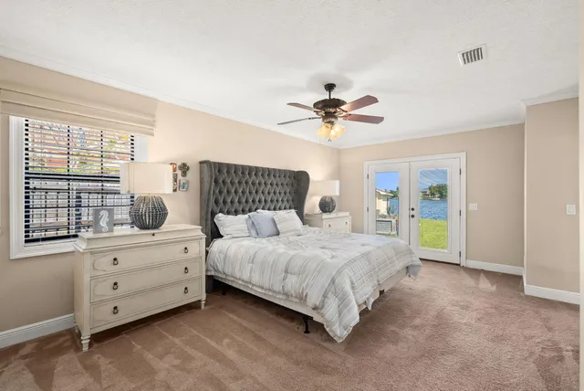 a bedroom with a bed and painting on the wall