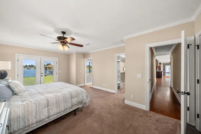 a bedroom with a large bed and a chandelier