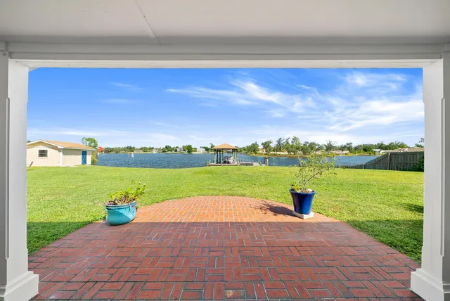 a view of a patio with a table chairs and wooden floor