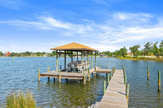 a view of a house with backyard porch and sitting area
