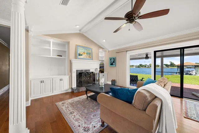 a living room with furniture fireplace and a large window