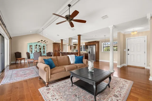 a living room with furniture a rug and a chandelier