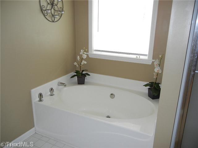 6925 Channel Forest Road Belews Creek, NC 27009 - Photo 11 of 16 Master Bath/Spa. Pretty garden tub with picture window! Imagine relaxing after a long day.