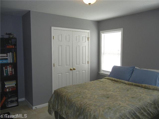 6925 Channel Forest Road Belews Creek, NC 27009 - Photo 12 of 16 2nd Bedroom. Spacious 2nd bedroom with double closet and overhead light fixture. Nice alcove to the left for added furniture.