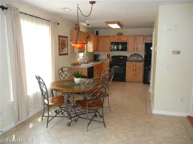 6925 Channel Forest Road Belews Creek, NC 27009 - Photo 3 of 16 Kitchen. Soacious breakfast area with large picture window, recently updated light fixtures.