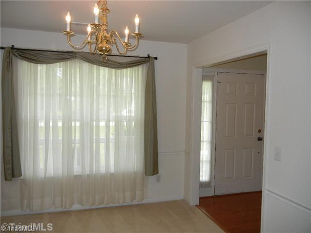 6925 Channel Forest Road Belews Creek, NC 27009 - Photo 5 of 16 Dining Room. Formal Dining room with neutral decor, chair rail and open to the foyer.