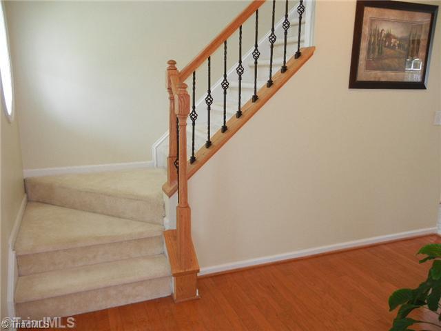 6925 Channel Forest Road Belews Creek, NC 27009 - Photo 7 of 16 Entry. The spacious entry has hardwood floors and windows for natural lighting! Seller added the attractive balusters. There is a half bath off the hallway which has a pedestal sink.