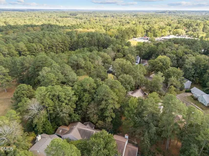 an aerial view of a houses with a yard