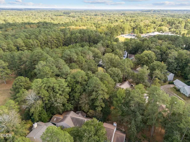an aerial view of a houses with a yard
