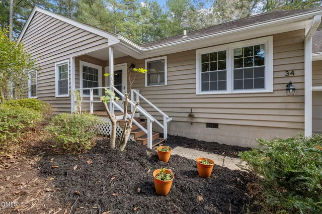 a backyard of a house with outdoor seating