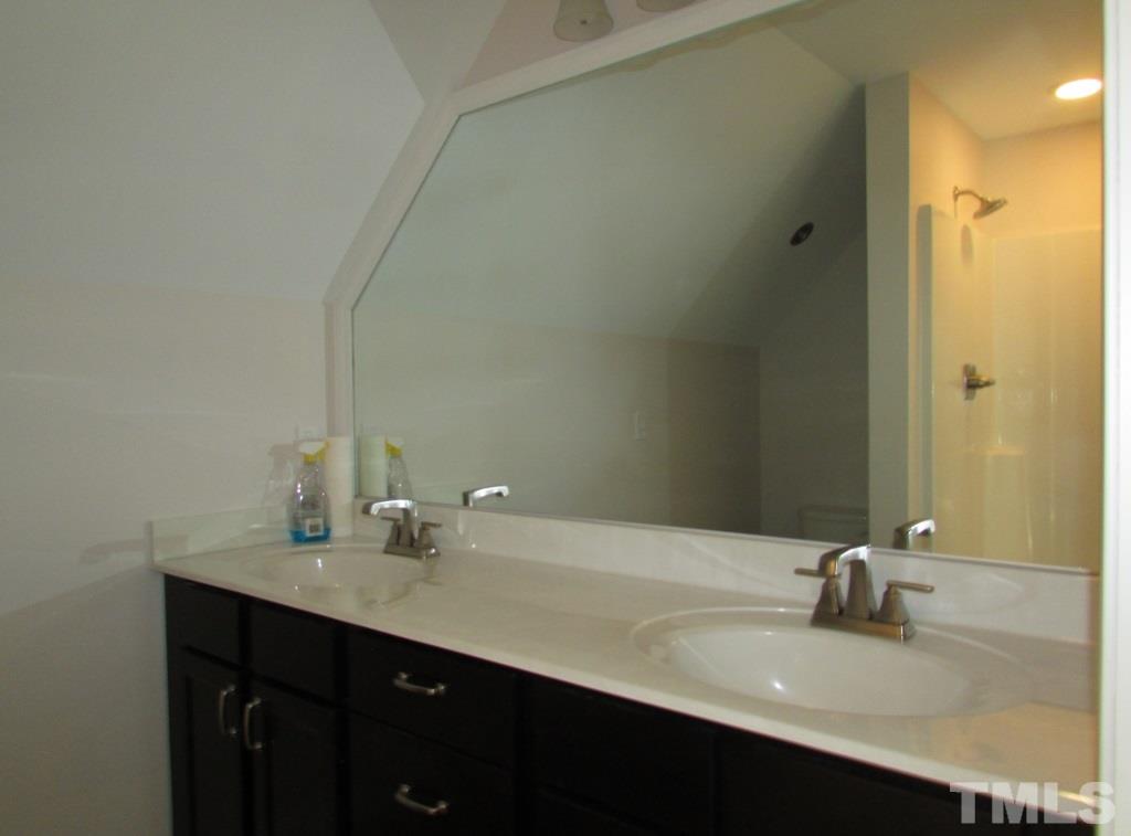 6477 Virgilina Road Roxboro, NC 27574 - Photo 13 of 20 a bathroom with a sink and a mirror