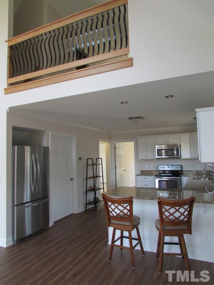 6477 Virgilina Road Roxboro, NC 27574 - Photo 6 of 20 a kitchen with stainless steel appliances granite countertop a kitchen island a stove a table and chairs