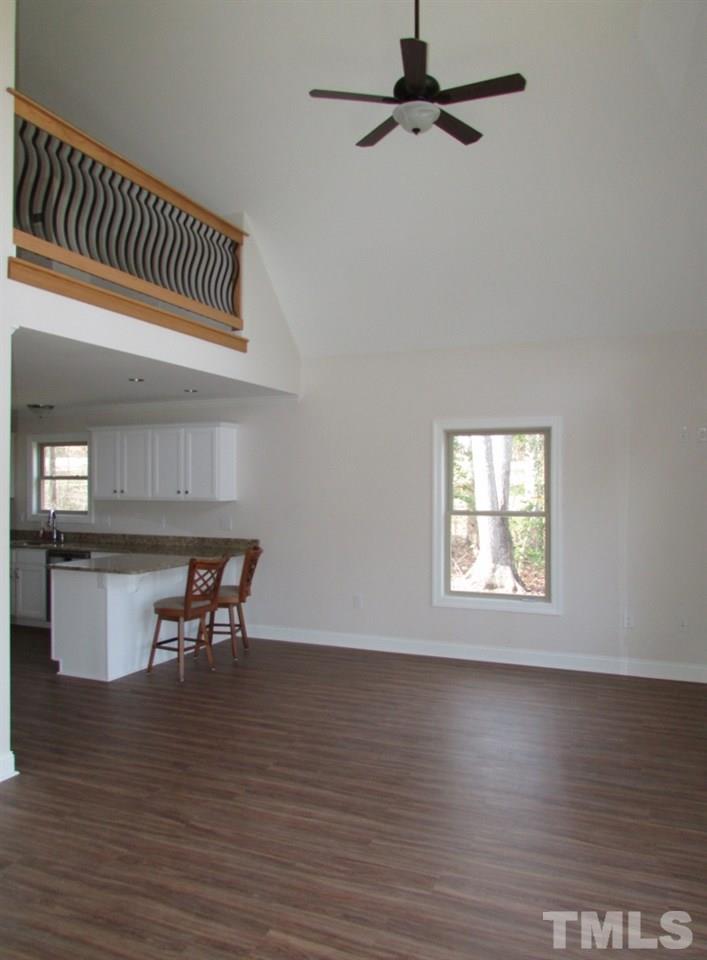 6477 Virgilina Road Roxboro, NC 27574 - Photo 7 of 20 an empty room with wooden floor table and chairs