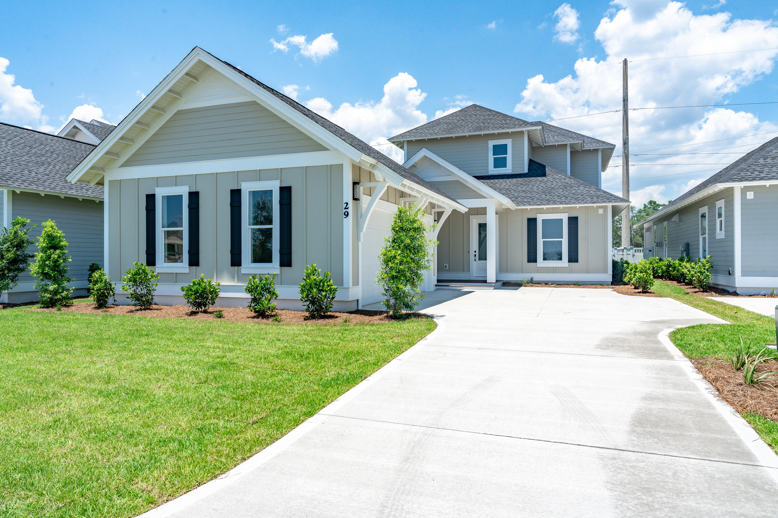 a front view of a house with yard and green space