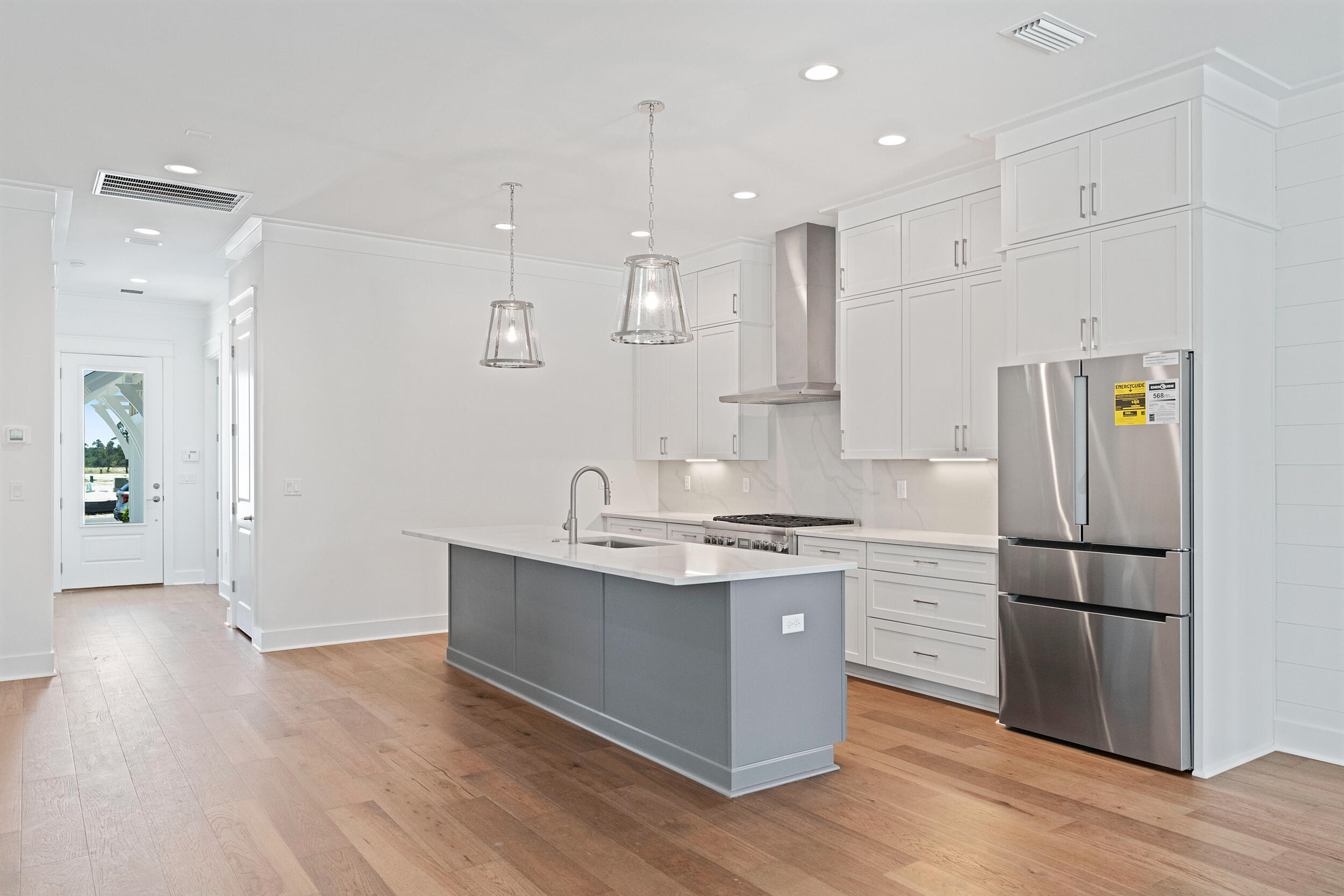 29 Pollard Cove, Unit LOT 3 Watersound, FL 32461 - Photo 12 of 69 a kitchen with kitchen island white cabinets and stainless steel appliances