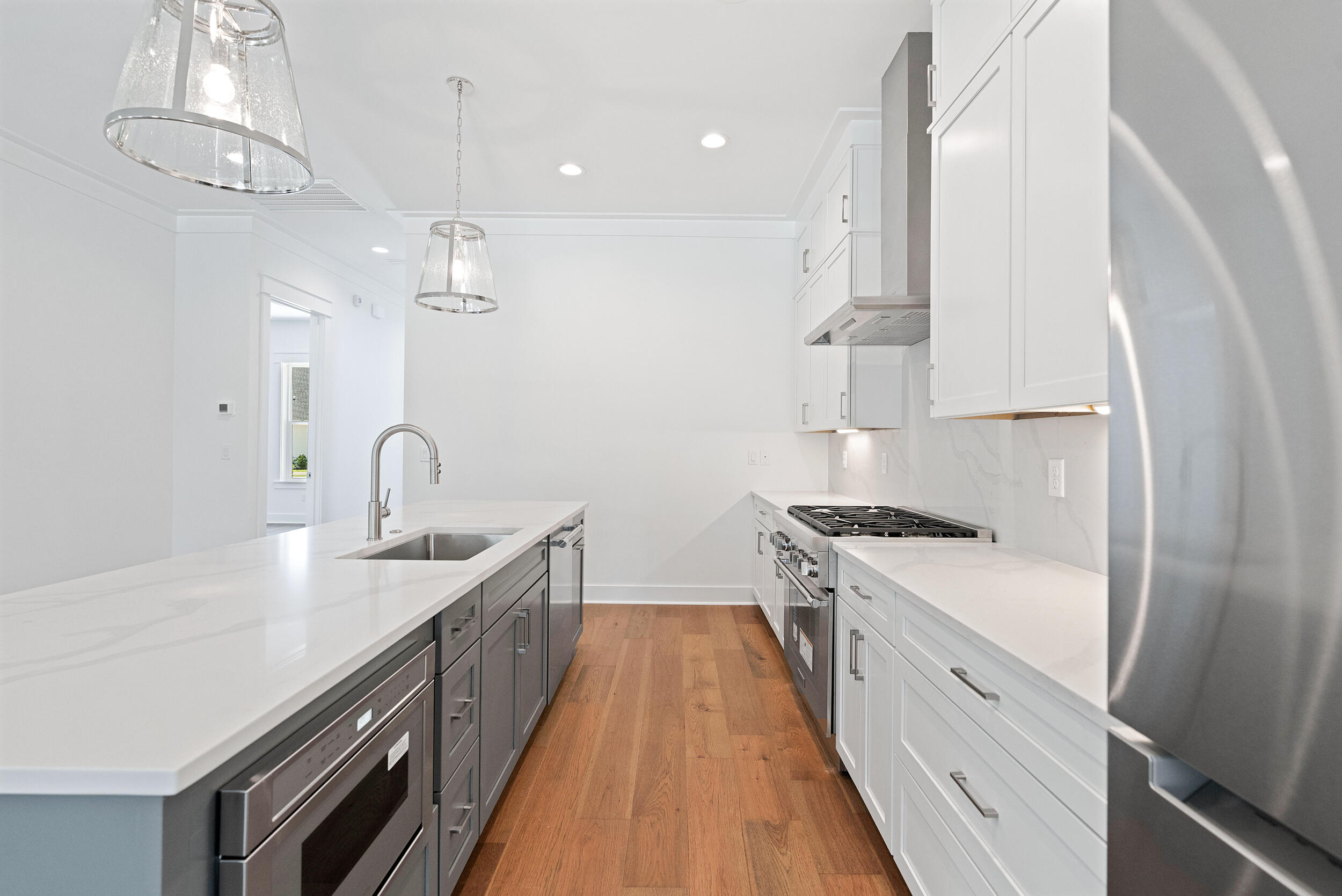 29 Pollard Cove, Unit LOT 3 Watersound, FL 32461 - Photo 13 of 69 a kitchen with stainless steel appliances a sink stove and refrigerator