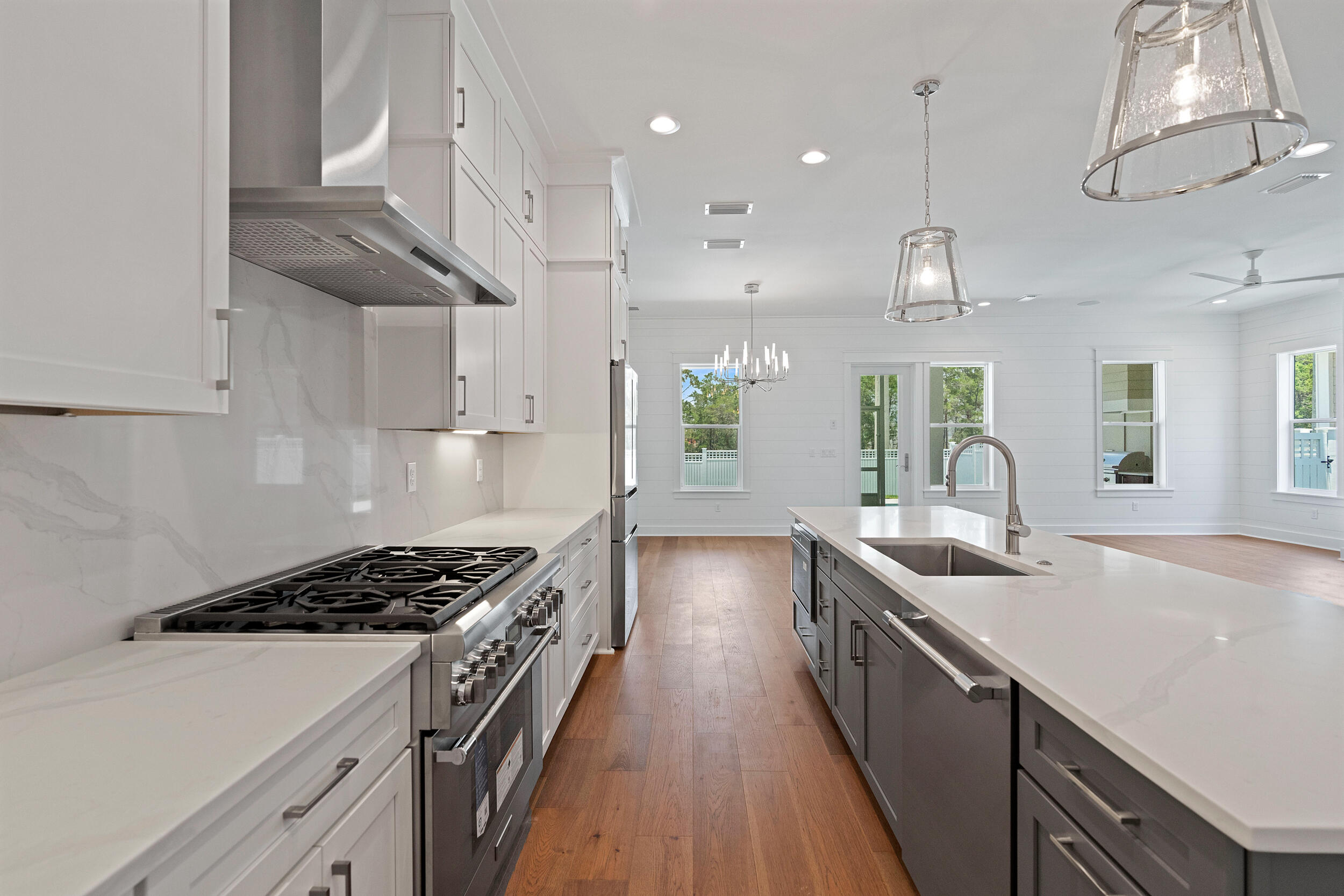 29 Pollard Cove, Unit LOT 3 Watersound, FL 32461 - Photo 15 of 69 a kitchen with kitchen island stainless steel appliances a sink a stove and a wooden floors
