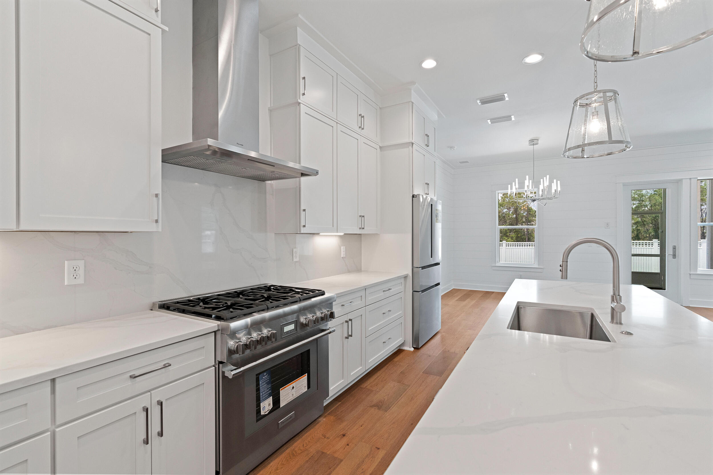 29 Pollard Cove, Unit LOT 3 Watersound, FL 32461 - Photo 16 of 69 a kitchen with stainless steel appliances granite countertop a sink a stove and cabinets