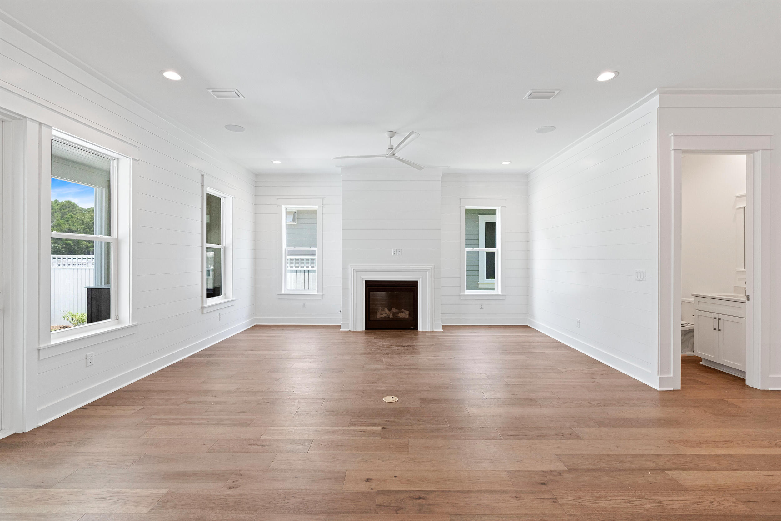 29 Pollard Cove, Unit LOT 3 Watersound, FL 32461 - Photo 17 of 69 an empty room with wooden floor fireplace and windows