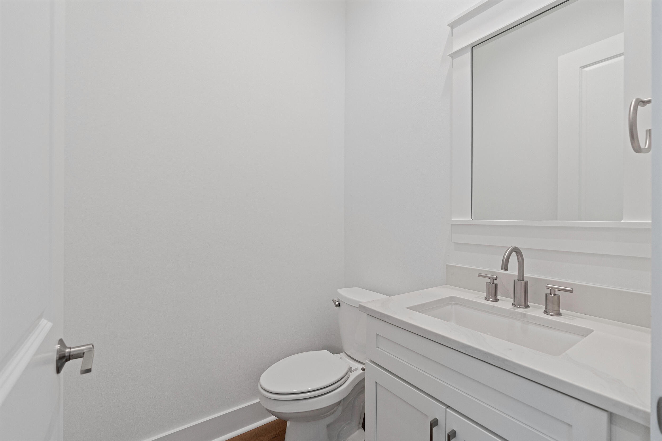 29 Pollard Cove, Unit LOT 3 Watersound, FL 32461 - Photo 18 of 69 a bathroom with a sink a toilet and a mirror