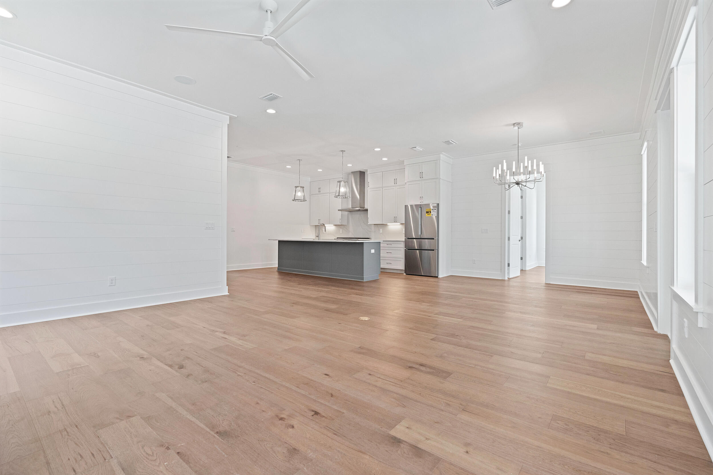 29 Pollard Cove, Unit LOT 3 Watersound, FL 32461 - Photo 21 of 69 a view of kitchen and empty room with wooden floor