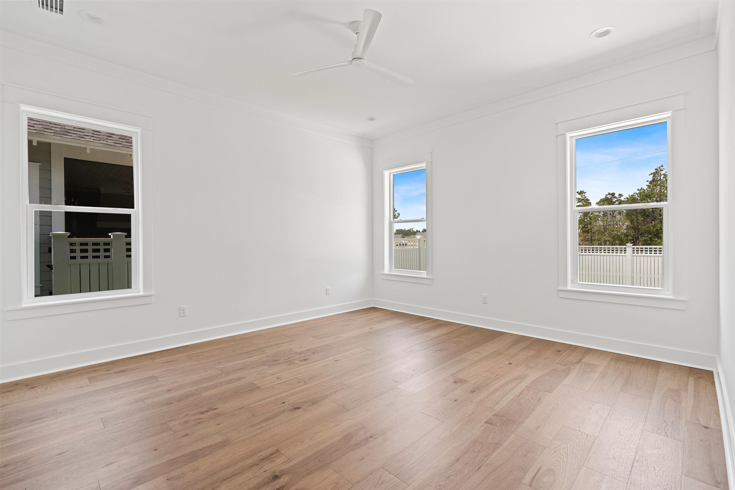 29 Pollard Cove, Unit LOT 3 Watersound, FL 32461 - Photo 24 of 69 a view of an empty room with wooden floor and a window