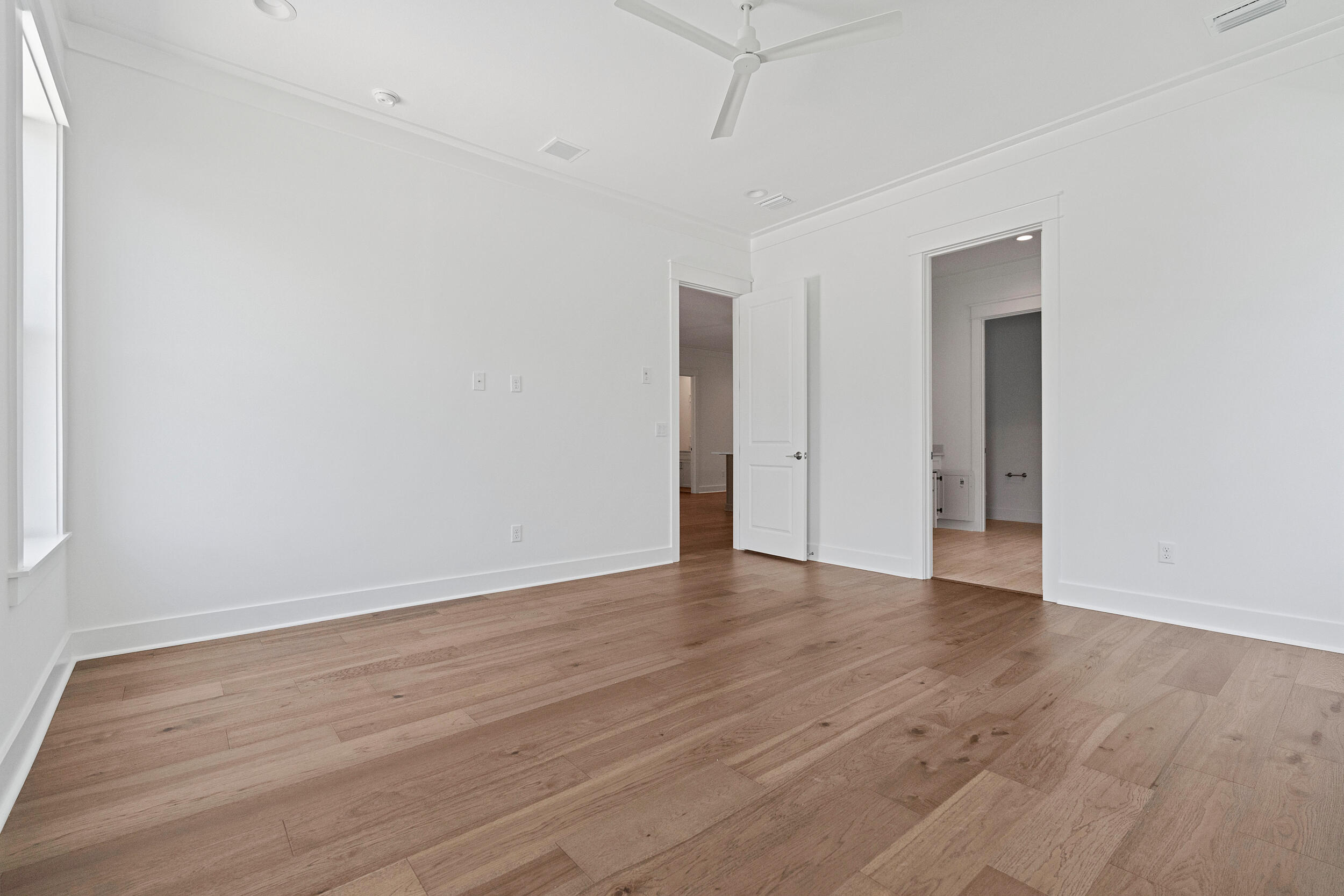 29 Pollard Cove, Unit LOT 3 Watersound, FL 32461 - Photo 25 of 69 a view of an empty room with wooden floor