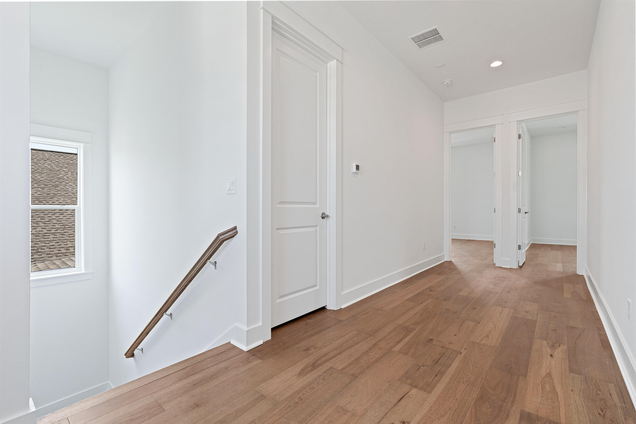 29 Pollard Cove, Unit LOT 3 Watersound, FL 32461 - Photo 28 of 69 a view of an empty room with wooden floor and stairs