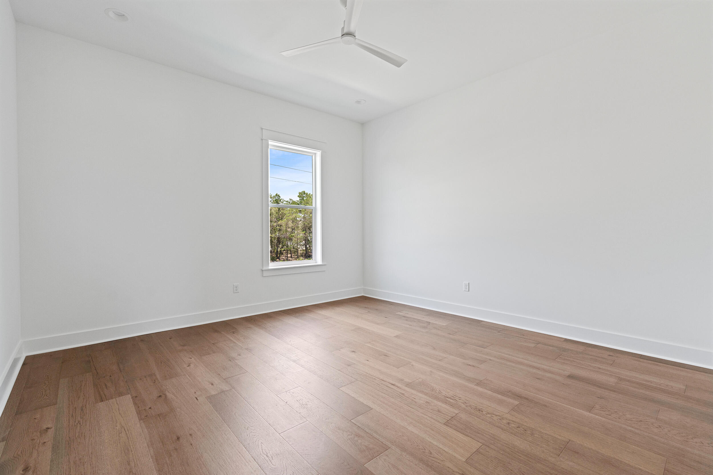 29 Pollard Cove, Unit LOT 3 Watersound, FL 32461 - Photo 29 of 69 an empty room with wooden floor and windows