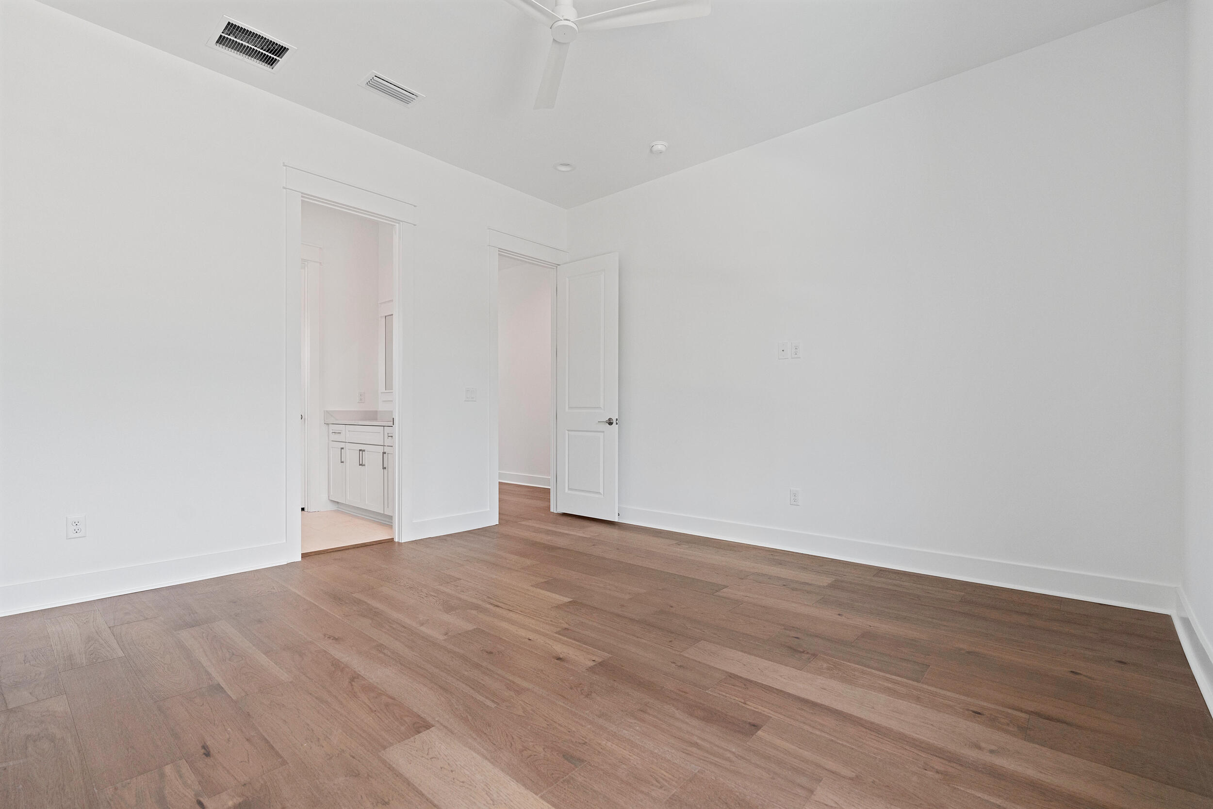 29 Pollard Cove, Unit LOT 3 Watersound, FL 32461 - Photo 30 of 69 a view of an empty room with wooden floor