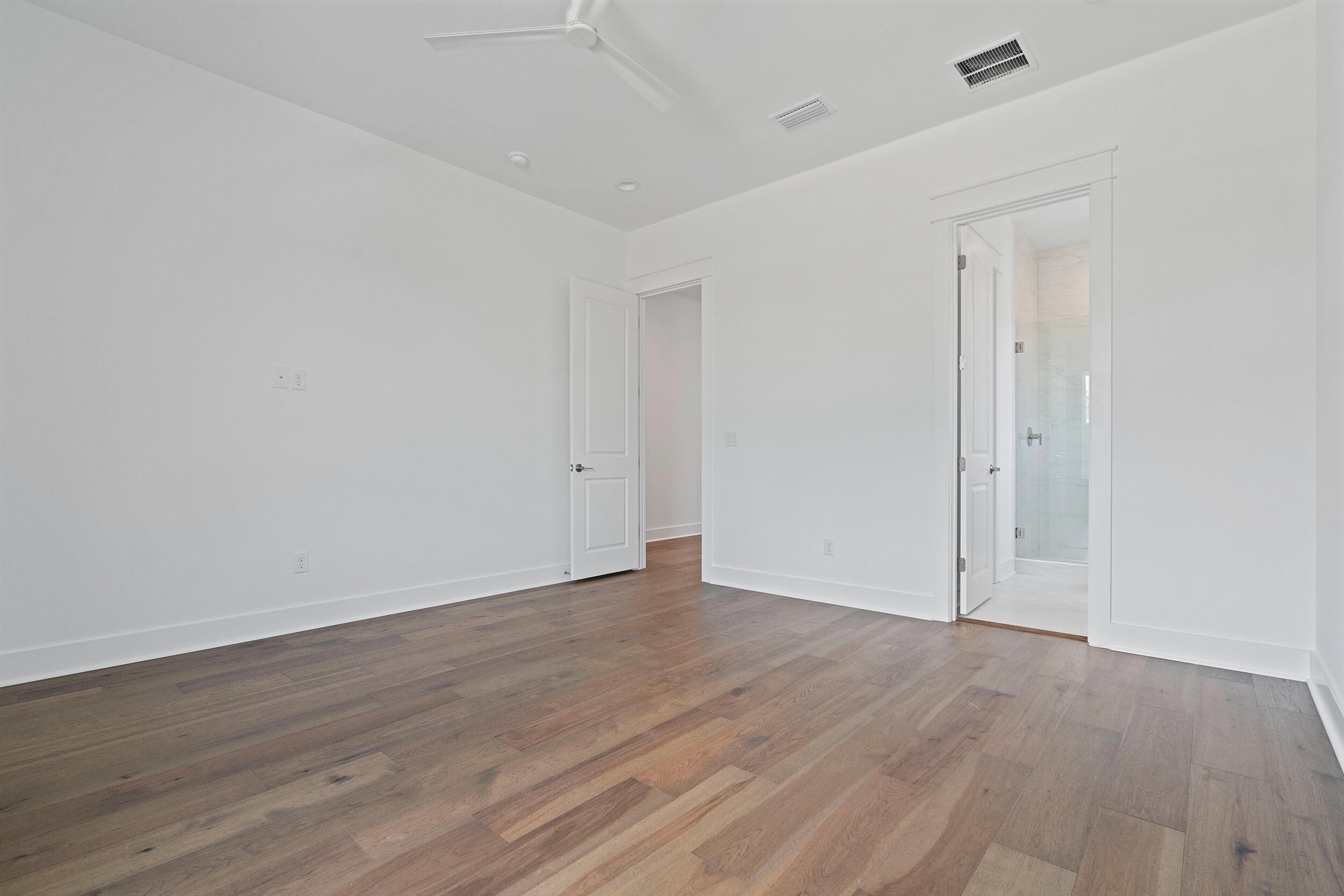 29 Pollard Cove, Unit LOT 3 Watersound, FL 32461 - Photo 33 of 69 a view of an empty room with wooden floor