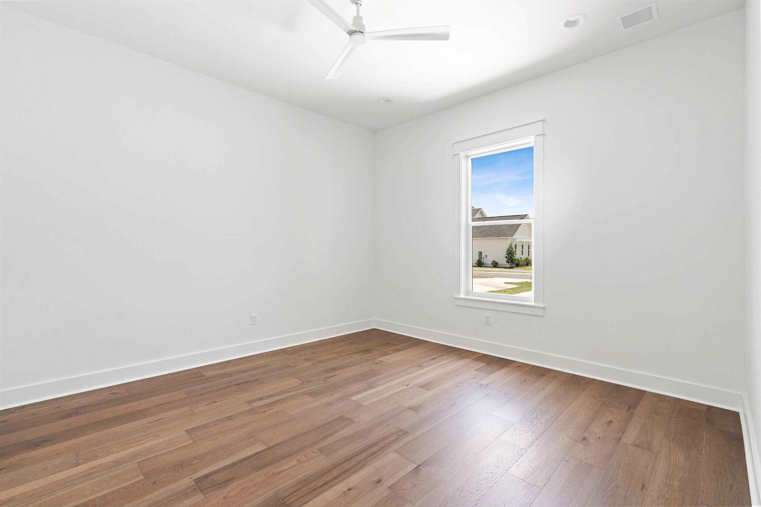 29 Pollard Cove, Unit LOT 3 Watersound, FL 32461 - Photo 7 of 69 an empty room with wooden floor and windows