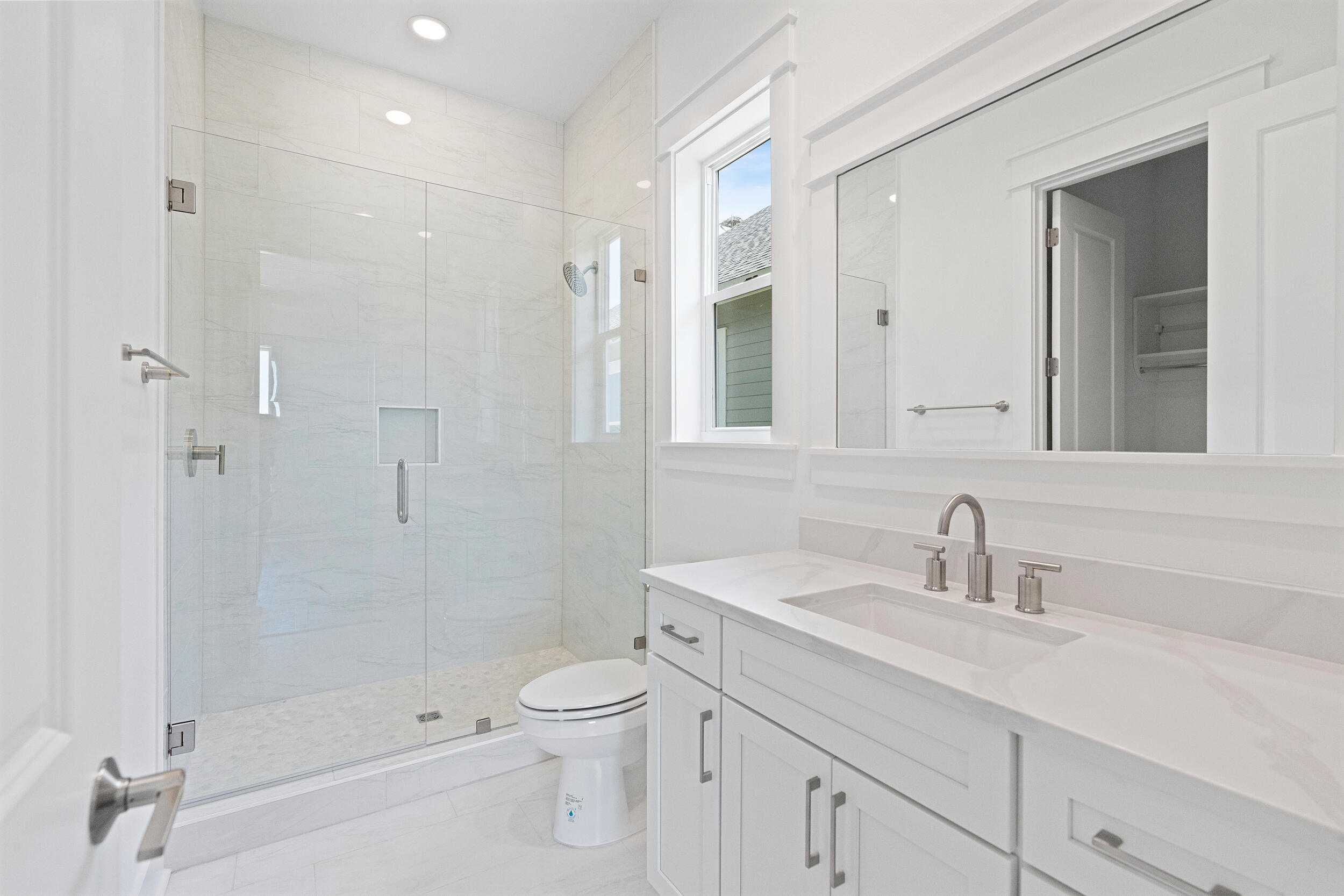 29 Pollard Cove, Unit LOT 3 Watersound, FL 32461 - Photo 9 of 69 a bathroom with a shower sink vanity mirror and toilet