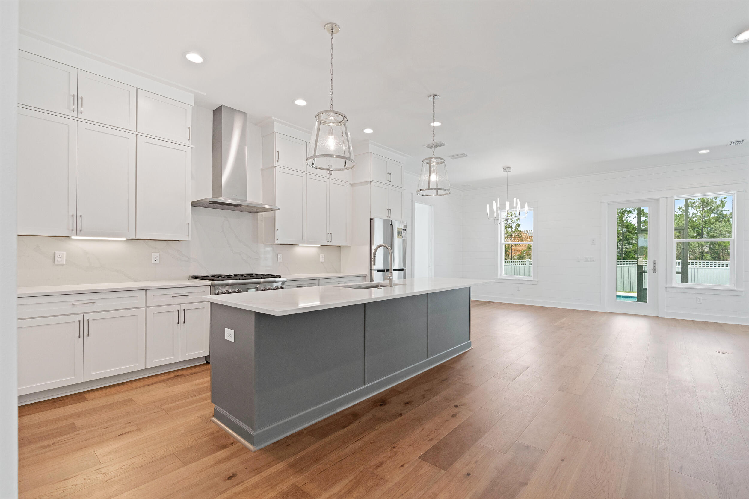 29 Pollard Cove, Unit LOT 3 Watersound, FL 32461 - Photo 10 of 69 a kitchen with stainless steel appliances granite countertop a sink a stove a refrigerator and white cabinets with wooden floor