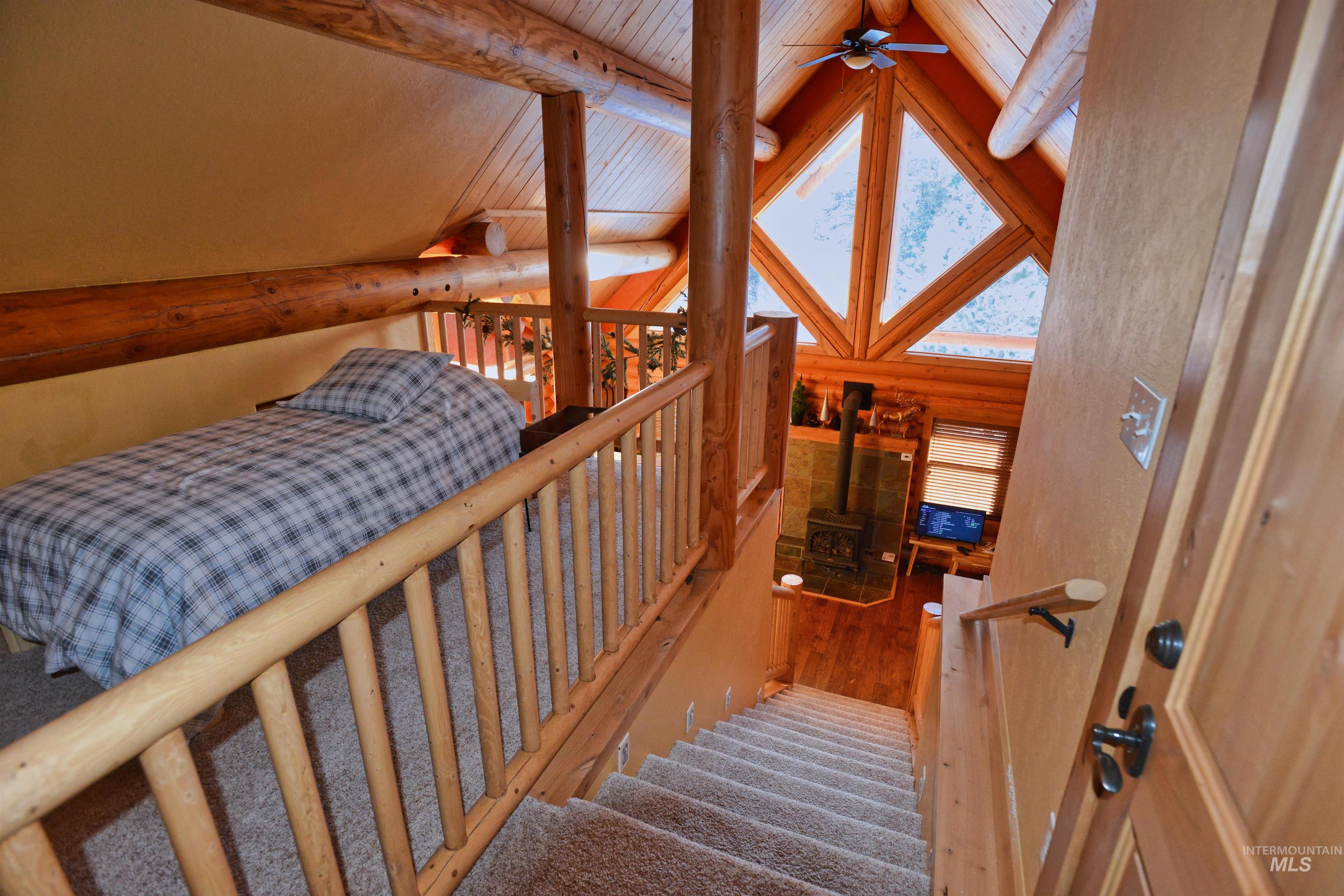 788 Chad Loop McCall, ID 83638 - Photo 11 of 22 Loft area with log railing, carpeted flooring, and exposed log beams