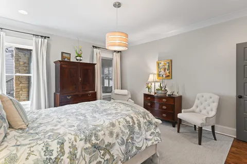 a bedroom with a bed and a dresser in it