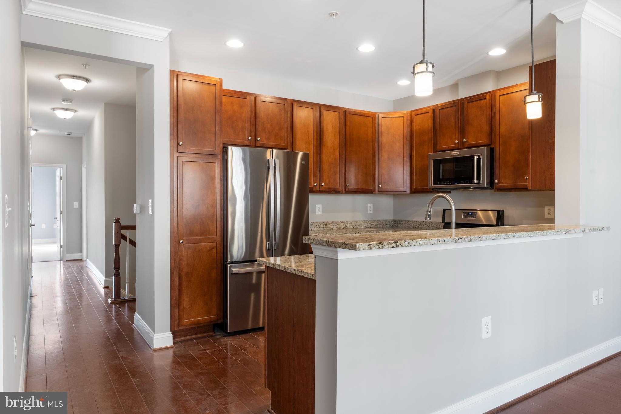11246 Chase Street, Unit 141 Fulton, MD 20759 - Photo 11 of 37 a view of a kitchen with a sink and a refrigerator