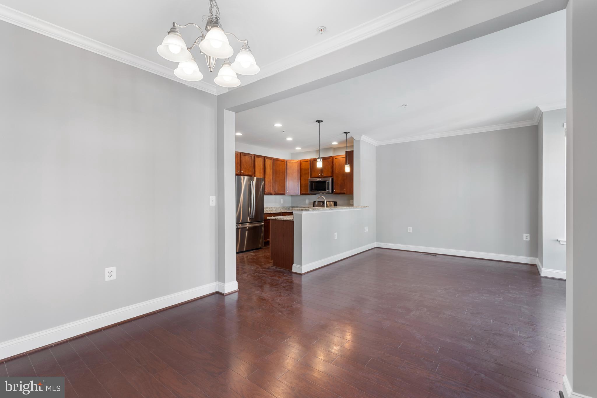 11246 Chase Street, Unit 141 Fulton, MD 20759 - Photo 17 of 37 a view of a kitchen with a microwave and a chandelier