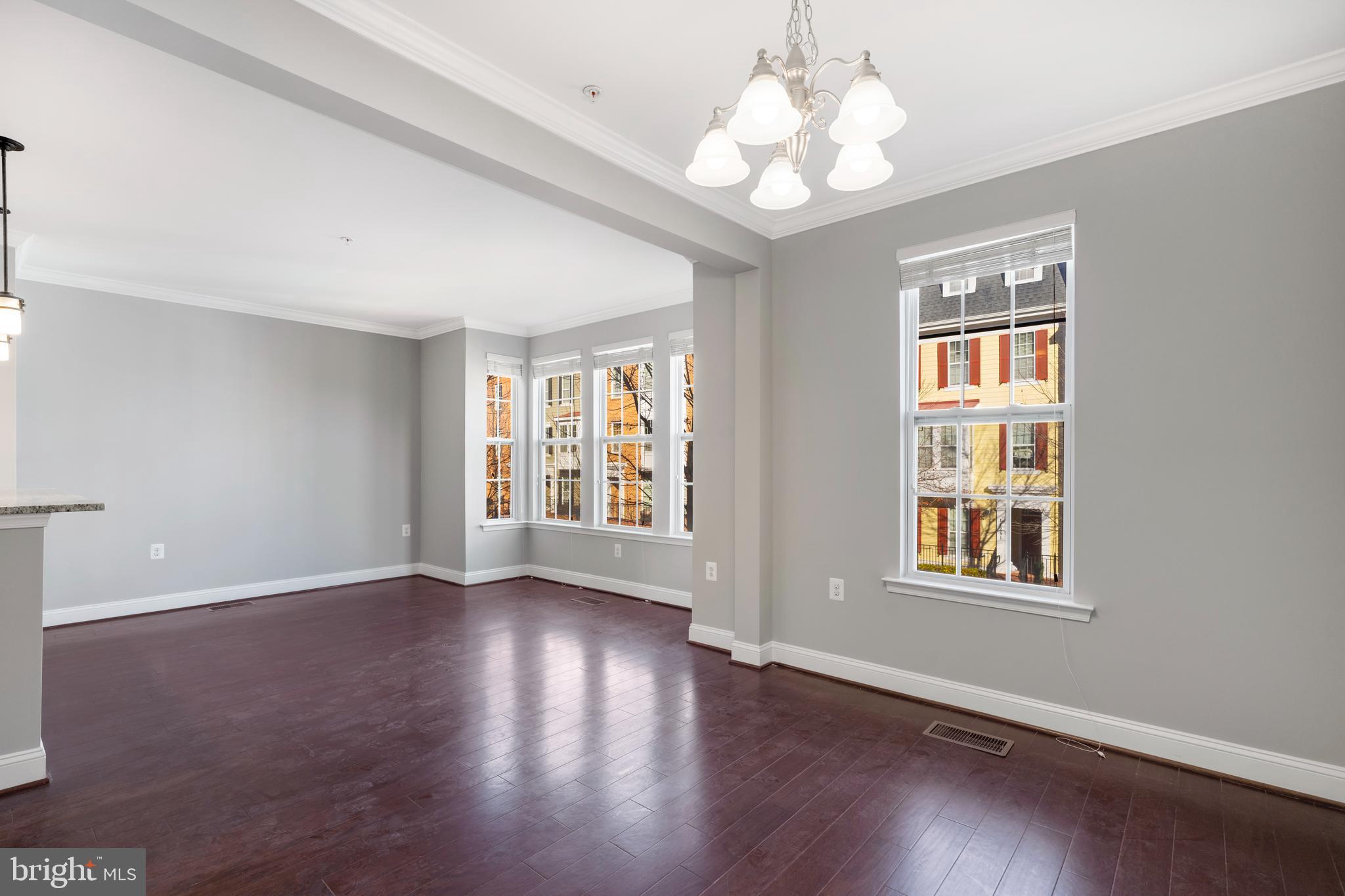 11246 Chase Street, Unit 141 Fulton, MD 20759 - Photo 18 of 37 a view of an empty room with wooden floor and a window