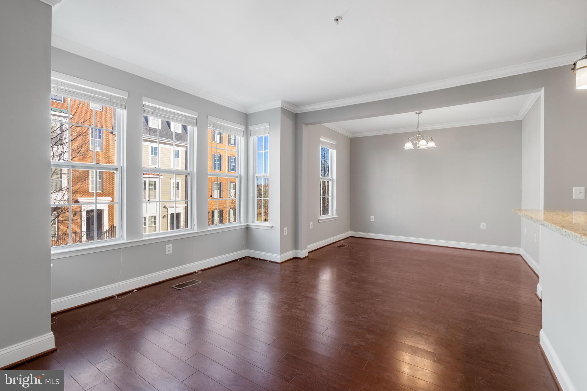11246 Chase Street, Unit 141 Fulton, MD 20759 - Photo 19 of 37 a view of an empty room with wooden floor and a window